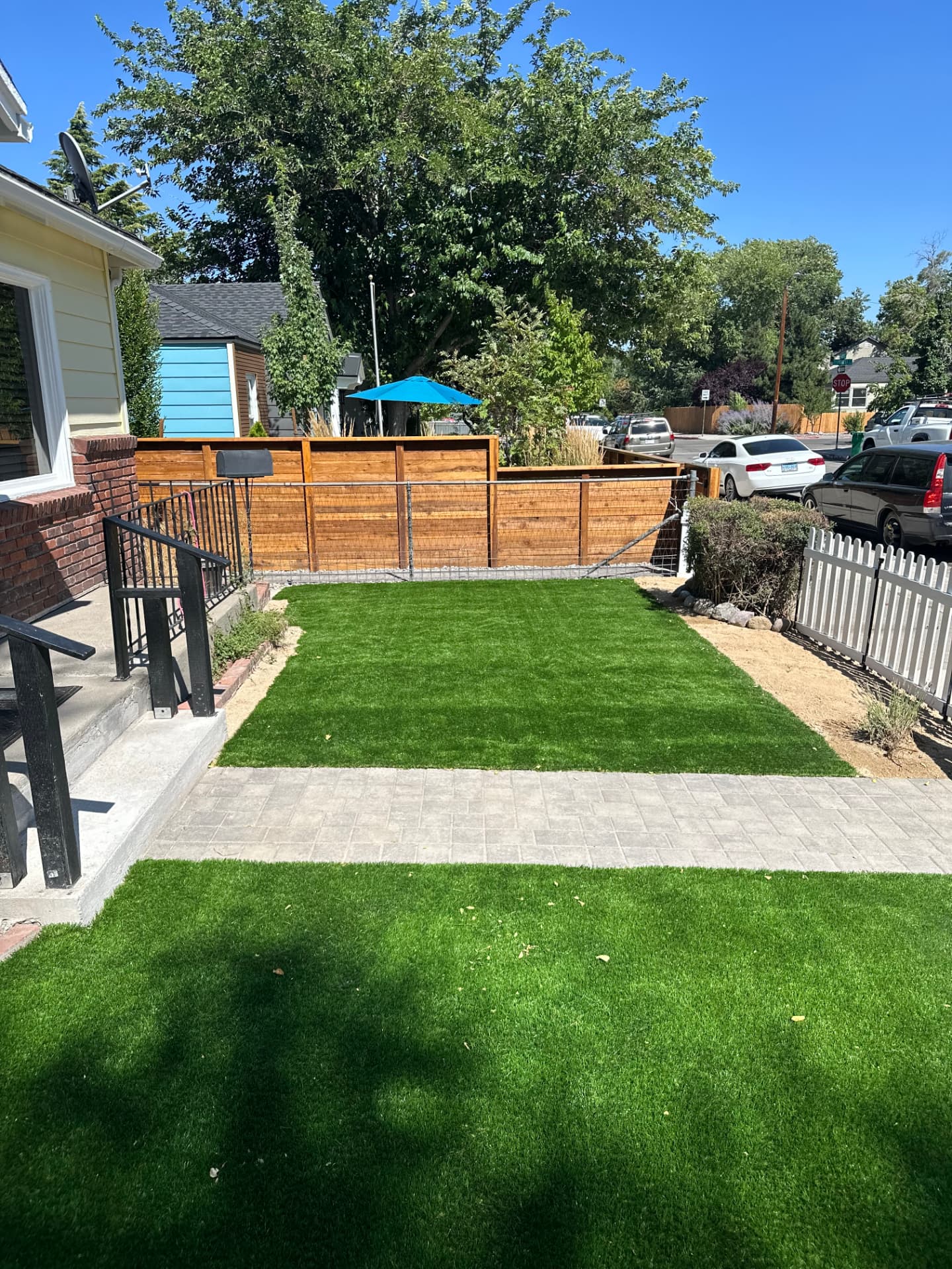 Front yard with paver walkway and fresh turf